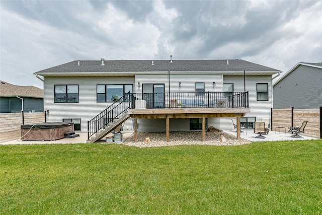 608 Pointer Cir, Center Point, IA 52213 - back of house featuring a hot tub, a patio, a wooden deck, stairs, and a fire pit