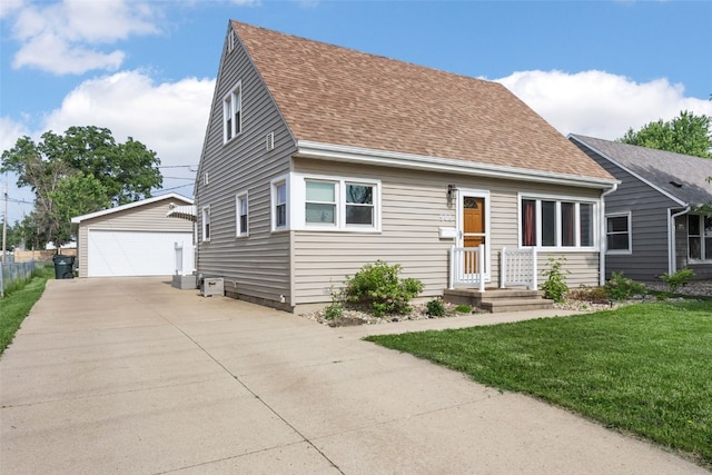908 18th St SW, Cedar Rapids, IA 52404 - cape cod home with a detached garage, an outbuilding, a front lawn, and roof with shingles