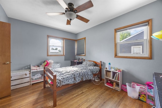 908 18th St SW, Cedar Rapids, IA 52404 - bedroom with wood finished floors and a ceiling fan