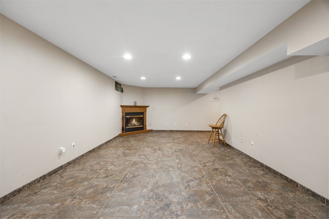 908 18th St SW, Cedar Rapids, IA 52404 - finished basement with a glass covered fireplace, recessed lighting, and stone finish floors