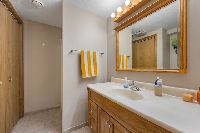 908 18th St SW, Cedar Rapids, IA 52404 - bathroom with vanity and a textured ceiling