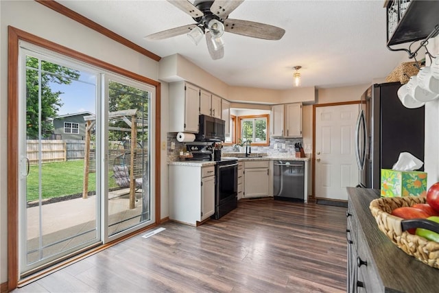 3210 5th St, Marion, IA 52302 - kitchen with appliances with stainless steel finishes, decorative backsplash, dark wood-style floors, and a ceiling fan