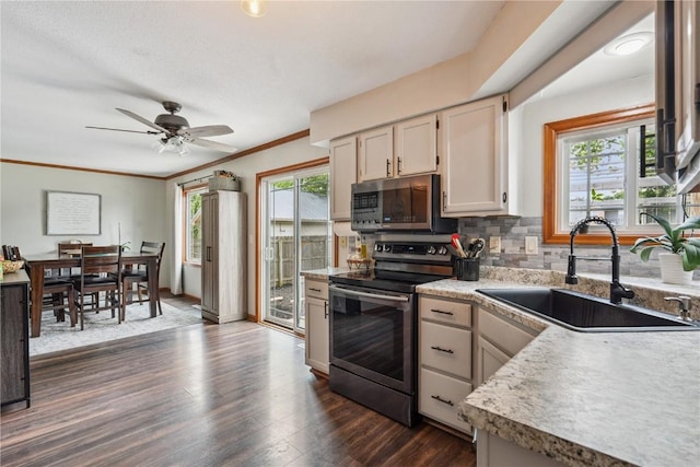 3210 5th St, Marion, IA 52302 - kitchen with stainless steel appliances, plenty of natural light, tasteful backsplash, light countertops, and crown molding
