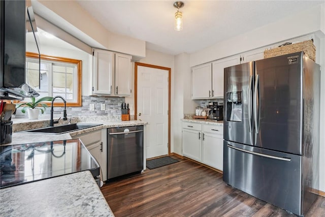 3210 5th St, Marion, IA 52302 - kitchen with appliances with stainless steel finishes, dark wood finished floors, white cabinetry, and backsplash