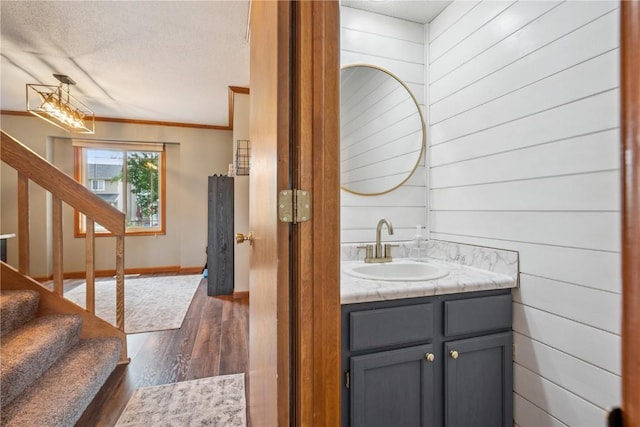 3210 5th St, Marion, IA 52302 - bathroom featuring vanity, crown molding, and wood finished floors