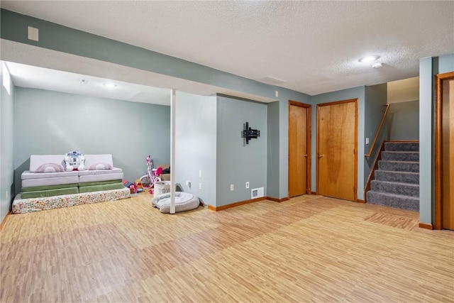 3210 5th St, Marion, IA 52302 - finished basement with wood finished floors, stairway, and a textured ceiling