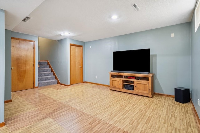 3210 5th St, Marion, IA 52302 - unfurnished living room with light wood finished floors, stairway, a textured ceiling, and recessed lighting