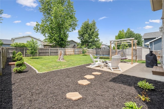 3210 5th St, Marion, IA 52302 - fenced backyard with a patio, a storage unit, and a trampoline