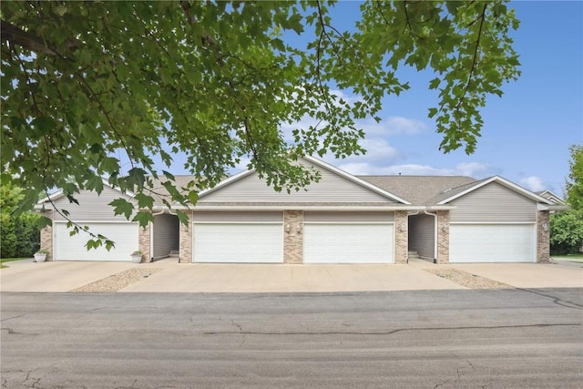 5752 Oakwood Ave NE Unit 3, Cedar Rapids, IA 52402 - view of front of property featuring driveway, a garage, and brick siding