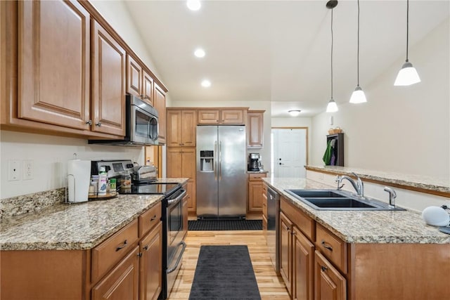 5752 Oakwood Ave NE Unit 3, Cedar Rapids, IA 52402 - kitchen featuring appliances with stainless steel finishes, light wood-type flooring, brown cabinets, decorative light fixtures, and recessed lighting