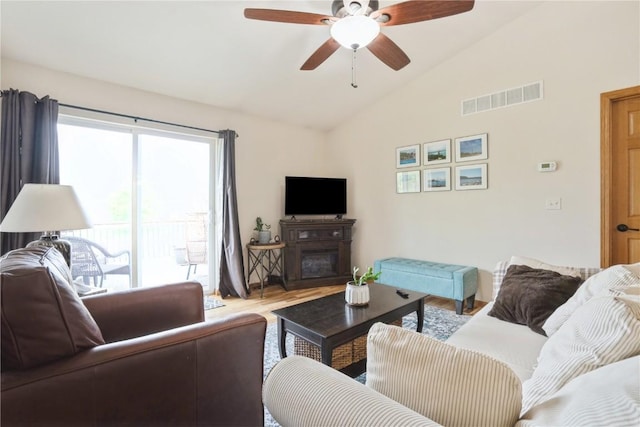 5752 Oakwood Ave NE Unit 3, Cedar Rapids, IA 52402 - living area featuring lofted ceiling, wood finished floors, a ceiling fan, and a glass covered fireplace