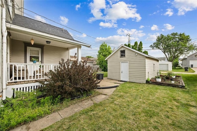 1307 8th St NW, Cedar Rapids, IA 52405 - view of green lawn with covered porch and an outbuilding