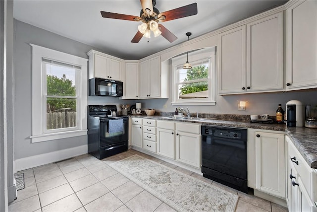1307 8th St NW, Cedar Rapids, IA 52405 - kitchen featuring black appliances, dark countertops, light tile patterned flooring, ceiling fan, and white cabinetry