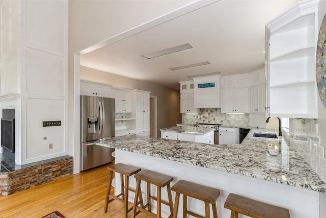 1916 Oak Knoll Ct SE, Cedar Rapids, IA 52403 - kitchen featuring stainless steel appliances, open shelves, a peninsula, white cabinetry, and light wood-type flooring