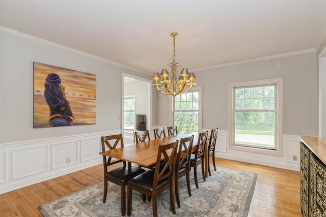 1916 Oak Knoll Ct SE, Cedar Rapids, IA 52403 - dining room with a chandelier, ornamental molding, light wood-style floors, and wainscoting