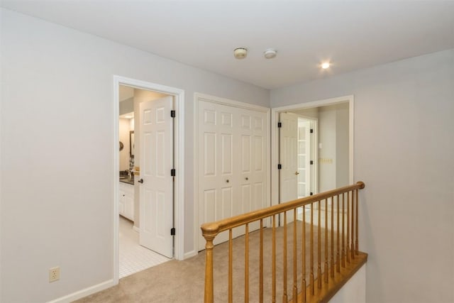 1916 Oak Knoll Ct SE, Cedar Rapids, IA 52403 - hall featuring light carpet and baseboards