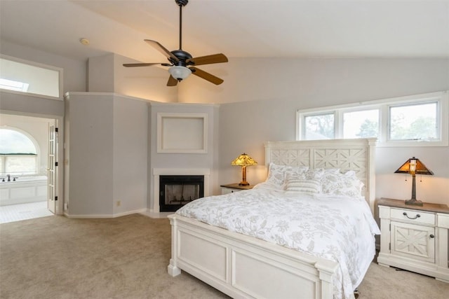 1916 Oak Knoll Ct SE, Cedar Rapids, IA 52403 - bedroom with light colored carpet, vaulted ceiling, a fireplace with flush hearth, ensuite bath, and a ceiling fan