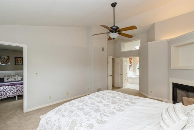 1916 Oak Knoll Ct SE, Cedar Rapids, IA 52403 - bedroom with light colored carpet, high vaulted ceiling, a fireplace, connected bathroom, and a ceiling fan