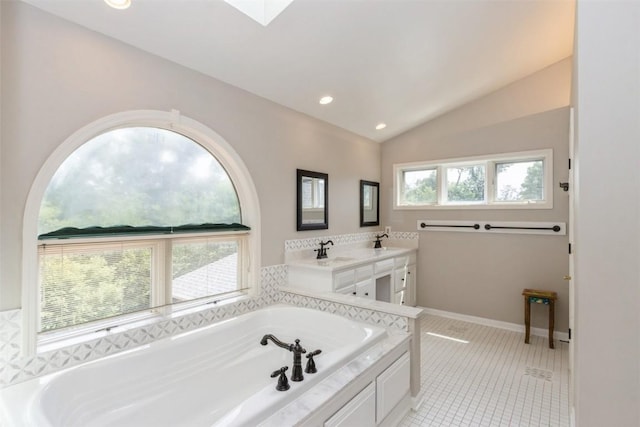 1916 Oak Knoll Ct SE, Cedar Rapids, IA 52403 - full bath featuring a bath, lofted ceiling, double vanity, a skylight, and tile patterned flooring