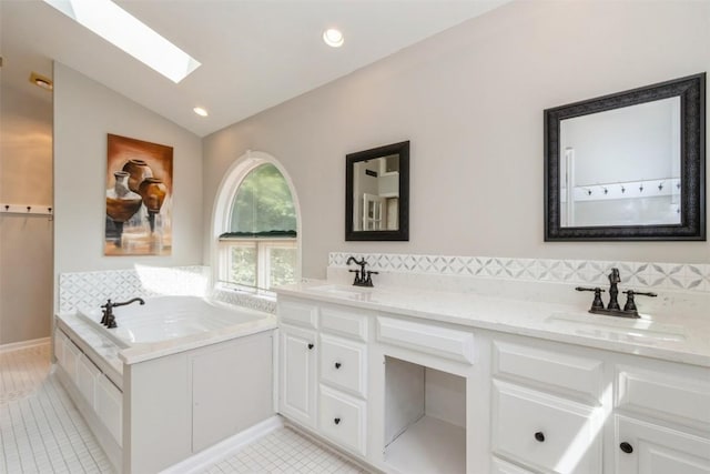 1916 Oak Knoll Ct SE, Cedar Rapids, IA 52403 - bathroom featuring a skylight, a bath, lofted ceiling, double vanity, and tile patterned flooring