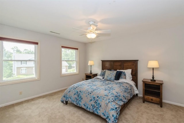 1916 Oak Knoll Ct SE, Cedar Rapids, IA 52403 - bedroom with light carpet and ceiling fan
