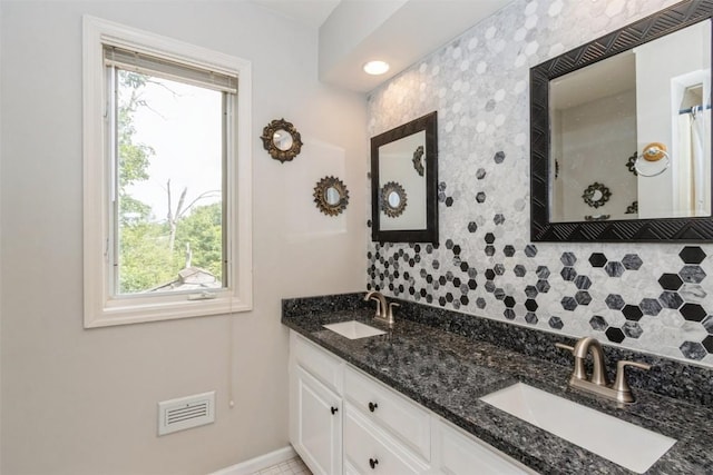 1916 Oak Knoll Ct SE, Cedar Rapids, IA 52403 - full bathroom with healthy amount of natural light, tasteful backsplash, double vanity, and a shower with curtain