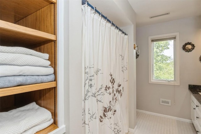 1916 Oak Knoll Ct SE, Cedar Rapids, IA 52403 - bathroom with vanity, tile patterned floors, and curtained shower