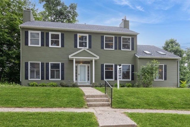 1916 Oak Knoll Ct SE, Cedar Rapids, IA 52403 - colonial home with a chimney, a front yard, and a shingled roof
