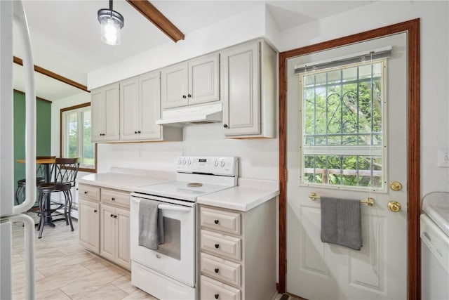 5995 32nd Ave, Shellsburg, IA 52332 - kitchen featuring white range with electric stovetop, under cabinet range hood, healthy amount of natural light, and light countertops