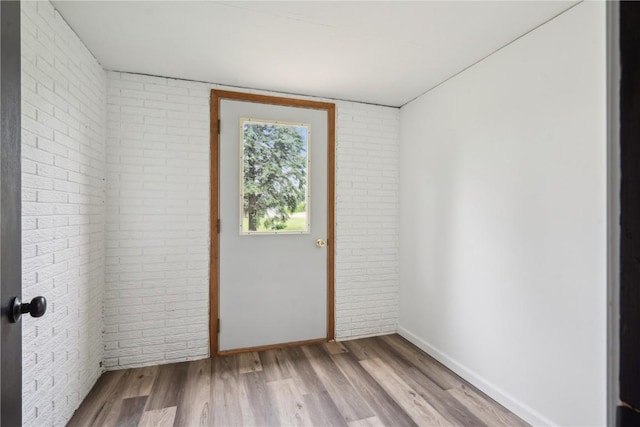 5995 32nd Ave, Shellsburg, IA 52332 - unfurnished room with brick wall and wood finished floors