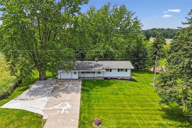 5995 32nd Ave, Shellsburg, IA 52332 - ranch-style home with concrete driveway, a front lawn, an attached garage, and a view of trees