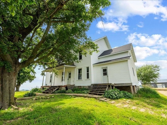 1931 140th St, Lowden, IA 52255 - rear view of property featuring a yard