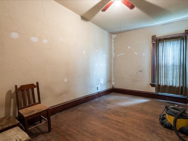 1931 140th St, Lowden, IA 52255 - spare room with wood finished floors and a ceiling fan