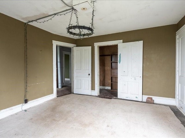 1931 140th St, Lowden, IA 52255 - unfurnished bedroom with baseboards and a chandelier