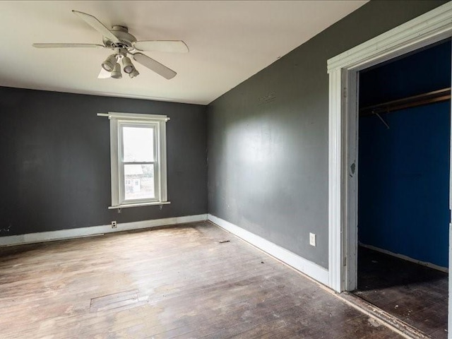 1931 140th St, Lowden, IA 52255 - unfurnished bedroom featuring wood finished floors, a closet, and ceiling fan