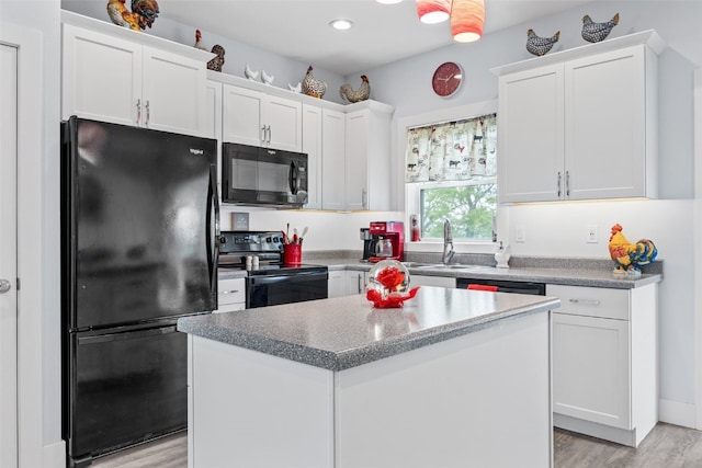 1062 Oak View Ct, Tipton, IA 52772 - kitchen with black appliances, white cabinetry, light wood finished floors, a kitchen island, and recessed lighting