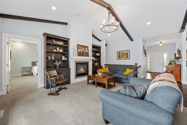 1062 Oak View Ct, Tipton, IA 52772 - carpeted living room with a chandelier, recessed lighting, and a fireplace