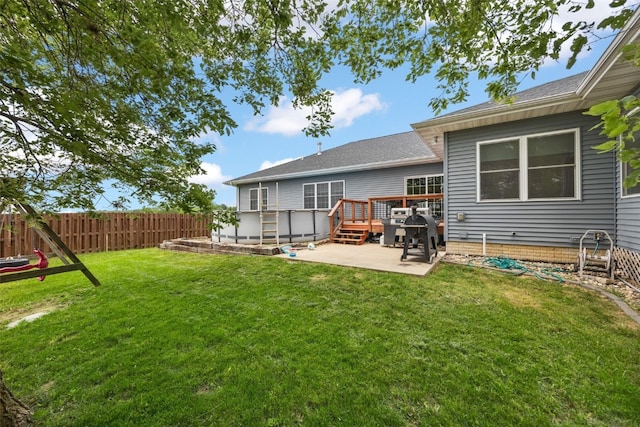 1062 Oak View Ct, Tipton, IA 52772 - rear view of property featuring a patio, a wooden deck, and a shingled roof