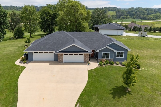 1062 Oak View Ct, Tipton, IA 52772 - view of front of house featuring a garage, concrete driveway, a front yard, and roof with shingles