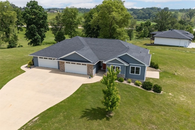 1062 Oak View Ct, Tipton, IA 52772 - view of front of property featuring an attached garage, concrete driveway, a front lawn, and roof with shingles