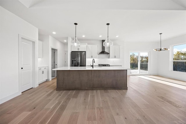2682 Burr Oak Ct, Marion, IA 52302 - kitchen featuring wall chimney range hood, stainless steel fridge with ice dispenser, light wood finished floors, light countertops, and recessed lighting
