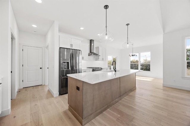 2682 Burr Oak Ct, Marion, IA 52302 - kitchen with appliances with stainless steel finishes, wall chimney exhaust hood, light wood-type flooring, an island with sink, and white cabinets