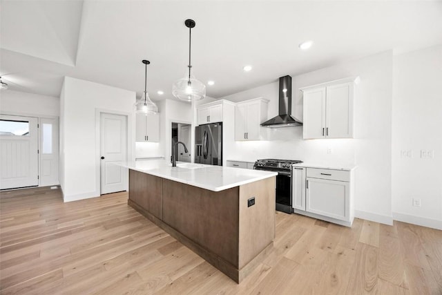 2682 Burr Oak Ct, Marion, IA 52302 - kitchen with wall chimney exhaust hood, stainless steel appliances, light countertops, light wood-style floors, and recessed lighting