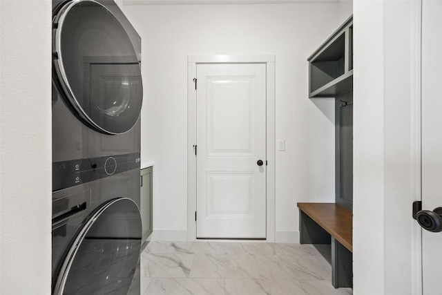 2682 Burr Oak Ct, Marion, IA 52302 - laundry room with stacked washer / dryer and marble look tile flooring