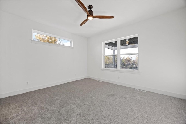 2682 Burr Oak Ct, Marion, IA 52302 - empty room with healthy amount of natural light, ceiling fan, and carpet flooring