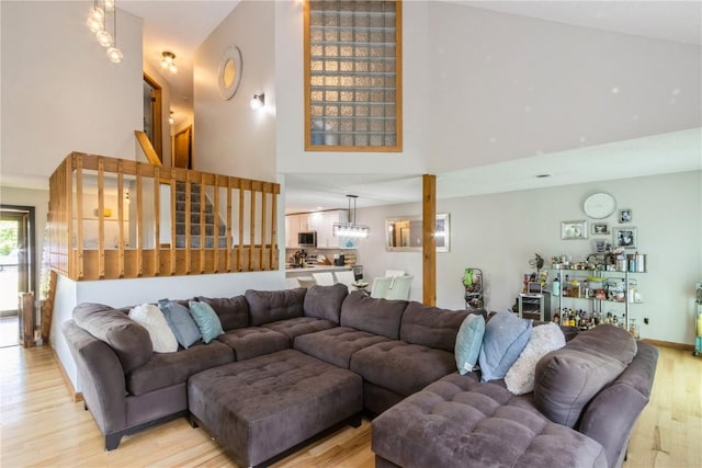 1932 N Ridge Dr, Coralville, IA 52241 - living area with a towering ceiling, light wood-style floors, and stairway