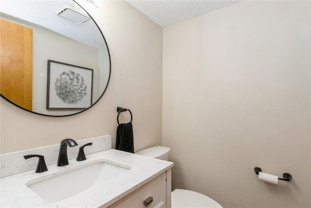 1932 N Ridge Dr, Coralville, IA 52241 - half bathroom with vanity and a textured ceiling