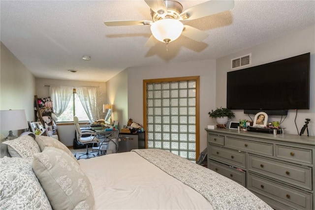 1932 N Ridge Dr, Coralville, IA 52241 - bedroom with a textured ceiling and a ceiling fan