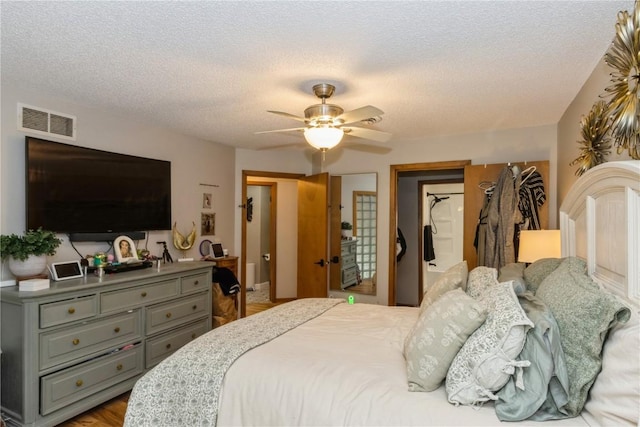 1932 N Ridge Dr, Coralville, IA 52241 - bedroom featuring a textured ceiling, a ceiling fan, and wood finished floors