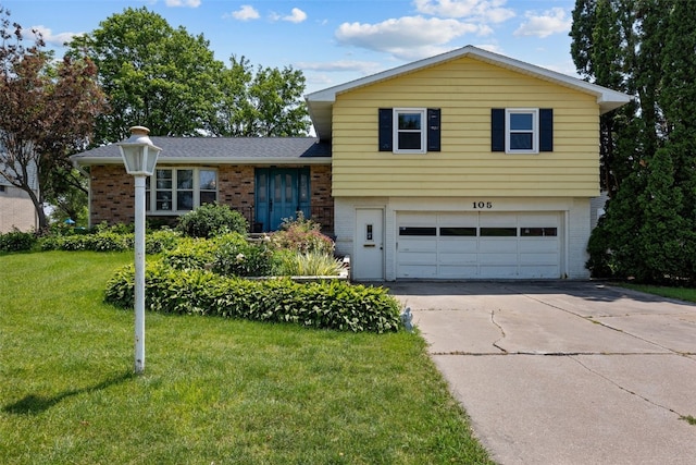 105 Parkview Dr, Tipton, IA 52772 - tri-level home featuring brick siding, an attached garage, a front lawn, and driveway